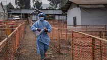 A health worker walks past a treatment centre in eastern Congo.