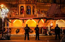 Security guards stand in front of a cordoned-off Christmas Market after a car crashed into a crowd of people, in Magdeburg, Germany,