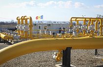 FILE - Men stand next to pipelines of the national natural gas distribution network outside Ungheni, Moldova, March 4, 2015. (AP Photo/Aurel Obreja)