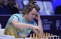 FILE - Norwegian Magnus Carlsen of SG Alpine Warriors plays Poland's Jan-Krzysztof Duda of Chingari Gulf Titans during Global Chess League, July 1, 2023, in Dubai, UAE
