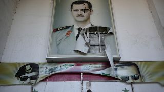A torn poster shows ousted Syrian President Bashar Al-Assad in Damascus, Syria, (14 December 2024)