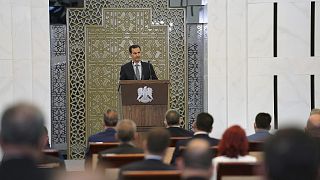 Syrian President Bashar al-Assad addresses the parliament, in Damascus, Syria, Wednesday, Aug. 12, 2020.