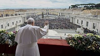 Pope Francis waves to faithful gathered for the Urbi et Orbi Christmas Day blessing from the main balcony of St. Peter's Basilica, 25 December 2023.
