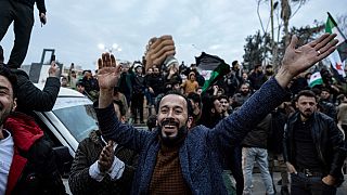 People gather to celebrate the fall of the Syrian government, in Manbij, Syria, Sunday, Dec. 8, 2024.