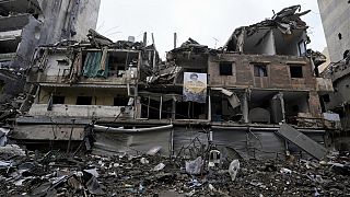 A picture of slain Hezbollah leader Hassan Nasrallah is attached on a destroyed building in Dahiyeh, Beirut, Lebanon, Wednesday, Nov. 27, 2024.