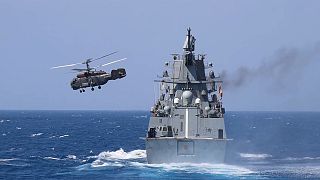 Russian frigate Admiral Grigorovich sails while the Kamov Ka-27 helicopter takes off from its flight deck during drills off the coast of Tartus, Syria. 