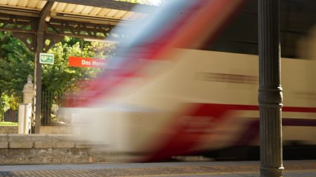 A commuter train circulates through a train station in Andalusia, Spain