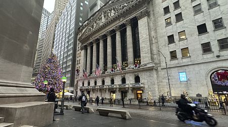 A scooter passes the New York Stock Exchange in New York's Financial District on Tuesday, Dec. 17, 2024.