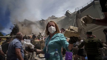 Emergency workers remove rubble and look for survivors at the site of Okhmatdyt children's hospital hit by Russian missiles, in Kyiv, Ukraine, 8 July 2024.