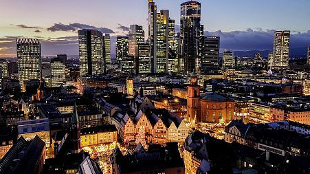 A Christmas market in Roemerberg square with the main business district in Frankfurt, Germany