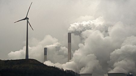 A wind turbine overlooks a coal-fired power station in Gelsenkirchen, Germany