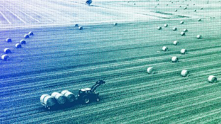 A farmer harvests his field at the Harz mountains near Wernigerode, July 2022