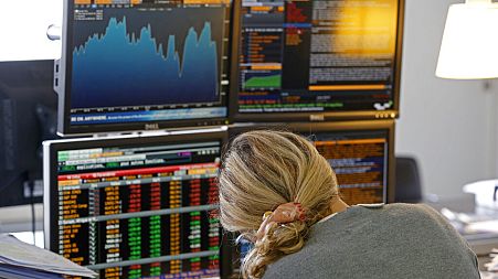 A fund manager looks at screens displaying activities of shares on the French Stock Exchange, in a financial analysis office in Paris, France, Tuesday, Aug. 25, 2015. 