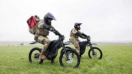 Soldiers ride eBikes to deliver refrigerated blood supplies to a field hospital during a training scenario.
