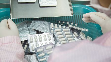 A health worker reviews medicines.