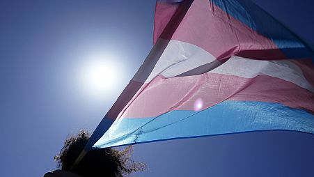 An attendee carries a transgender flag during a march in Portugal in March 2024.