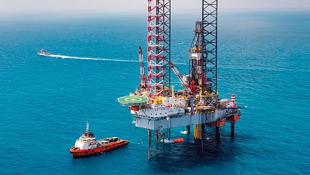 An offshore oil rig drilling platform in the middle of the ocean